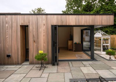 Garden gym, cedar cladding and open bi-fold doors, Macclesfield